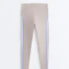 Legginsy kompresyjne z wysokim stanem i kontrastowymi wykończeniami, sięgające do kostek Legginsy kompresyjne z wysokim stanem i kontrastowymi wykończeniami, sięgające do kostek