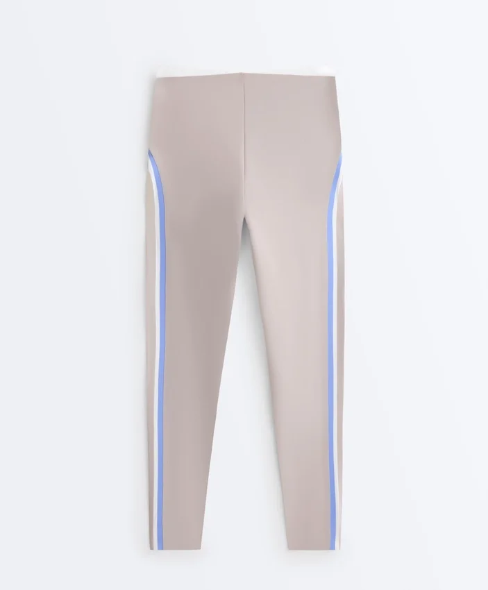 Legginsy kompresyjne z wysokim stanem i kontrastowymi wykończeniami, sięgające do kostek Legginsy kompresyjne z wysokim stanem i kontrastowymi wykończeniami, sięgające do kostek