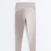 Legginsy kompresyjne z wysokim stanem i kontrastowymi wykończeniami, sięgające do kostek Legginsy kompresyjne z wysokim stanem i kontrastowymi wykończeniami, sięgające do kostek