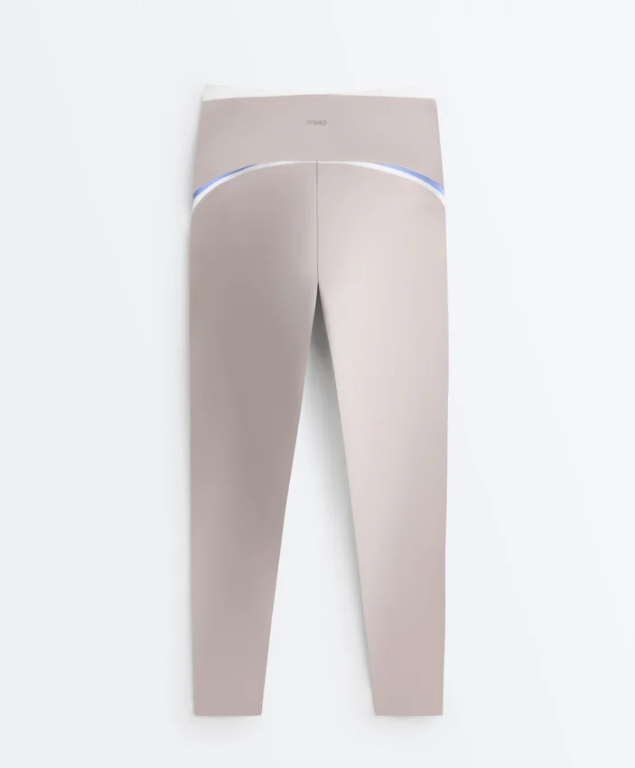 Legginsy kompresyjne z wysokim stanem i kontrastowymi wykończeniami, sięgające do kostek Legginsy kompresyjne z wysokim stanem i kontrastowymi wykończeniami, sięgające do kostek