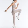 Legginsy kompresyjne z wysokim stanem i kontrastowymi wykończeniami, sięgające do kostek Legginsy kompresyjne z wysokim stanem i kontrastowymi wykończeniami, sięgające do kostek