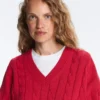 Swetr z dzianiny typu cable knit z dekoltem w serek, wykonany w 100% z bawełny